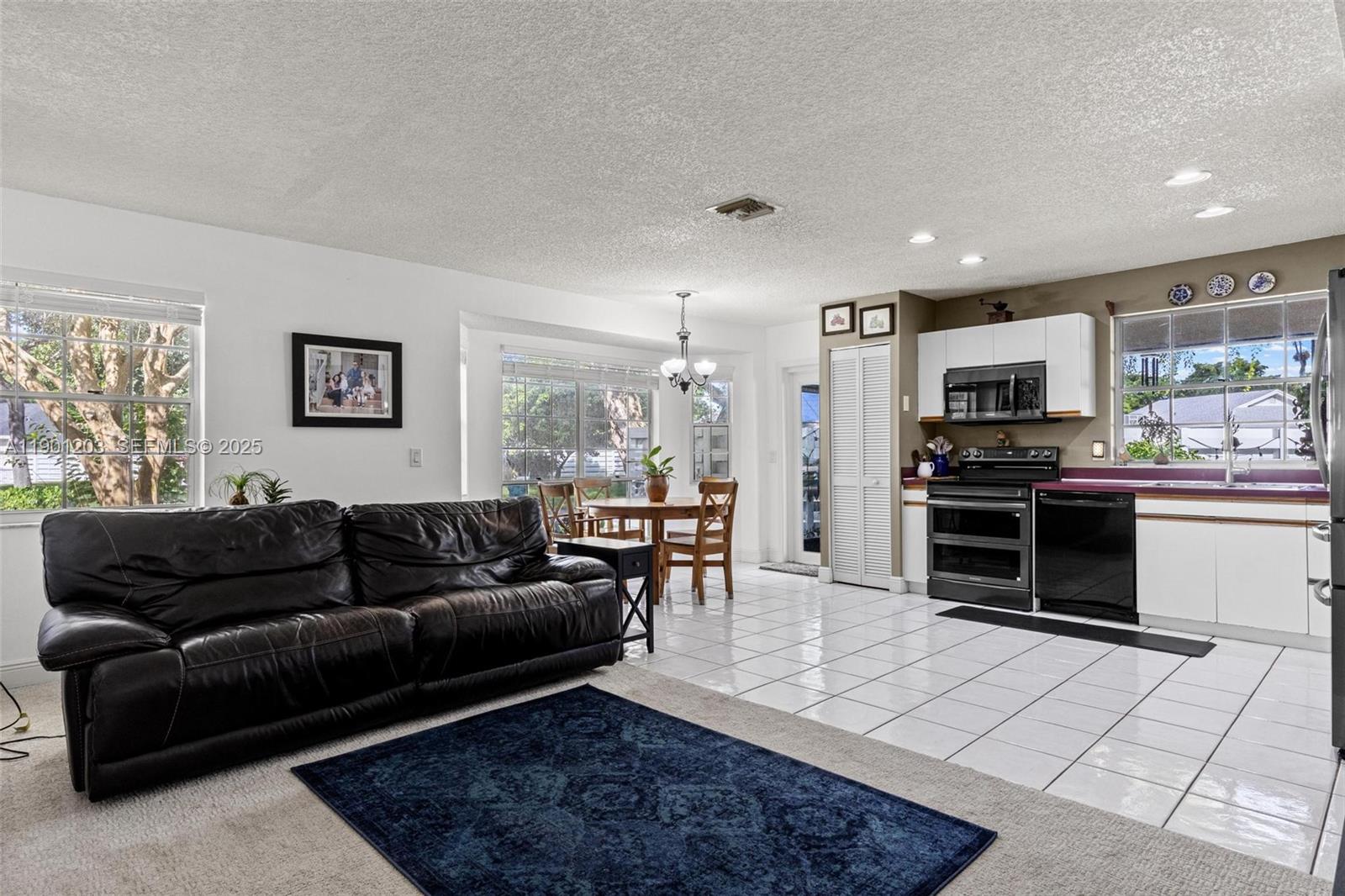14683 Southwest 145th Terrace Miami, FL 33186 - Photo 18 of 47 a living room with furniture and a wooden floor