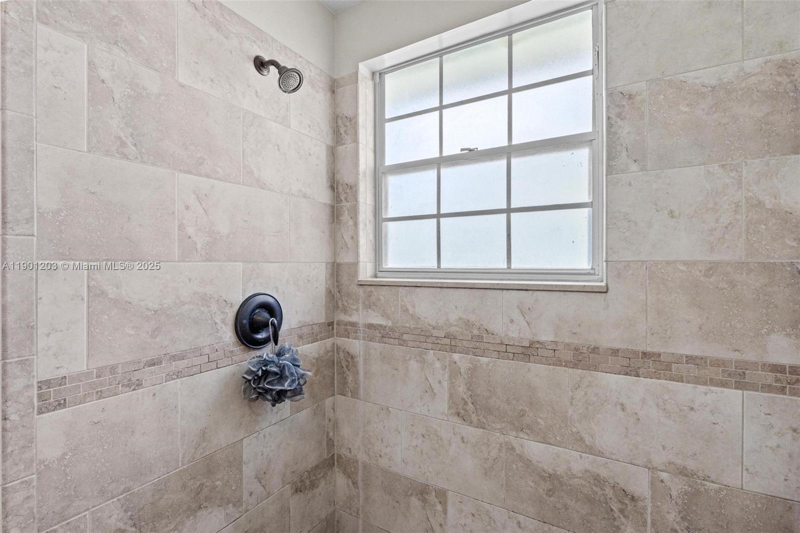 14683 Southwest 145th Terrace Miami, FL 33186 - Photo 28 of 47 a bathroom with a bathtub and a window