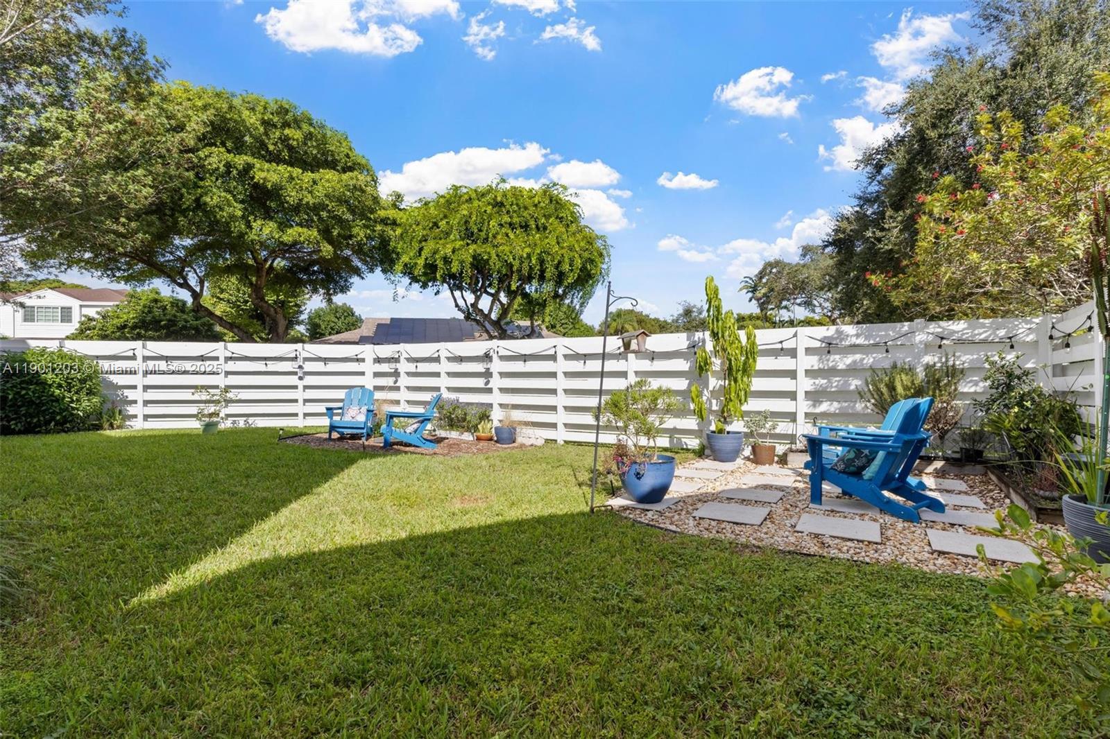 14683 Southwest 145th Terrace Miami, FL 33186 - Photo 32 of 47 a view of a garden with an outdoor seating