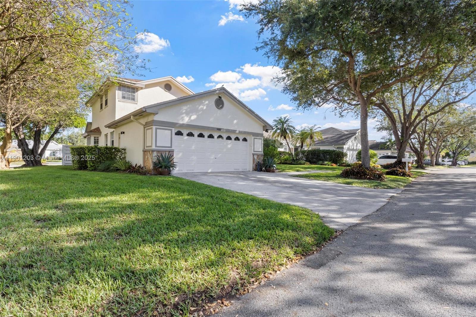 14683 Southwest 145th Terrace Miami, FL 33186 - Photo 35 of 47 a front view of a house with garden