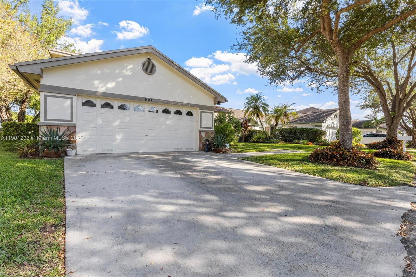 14683 Southwest 145th Terrace Miami, FL 33186 - Photo 37 of 47 a front view of a house with a yard and garage