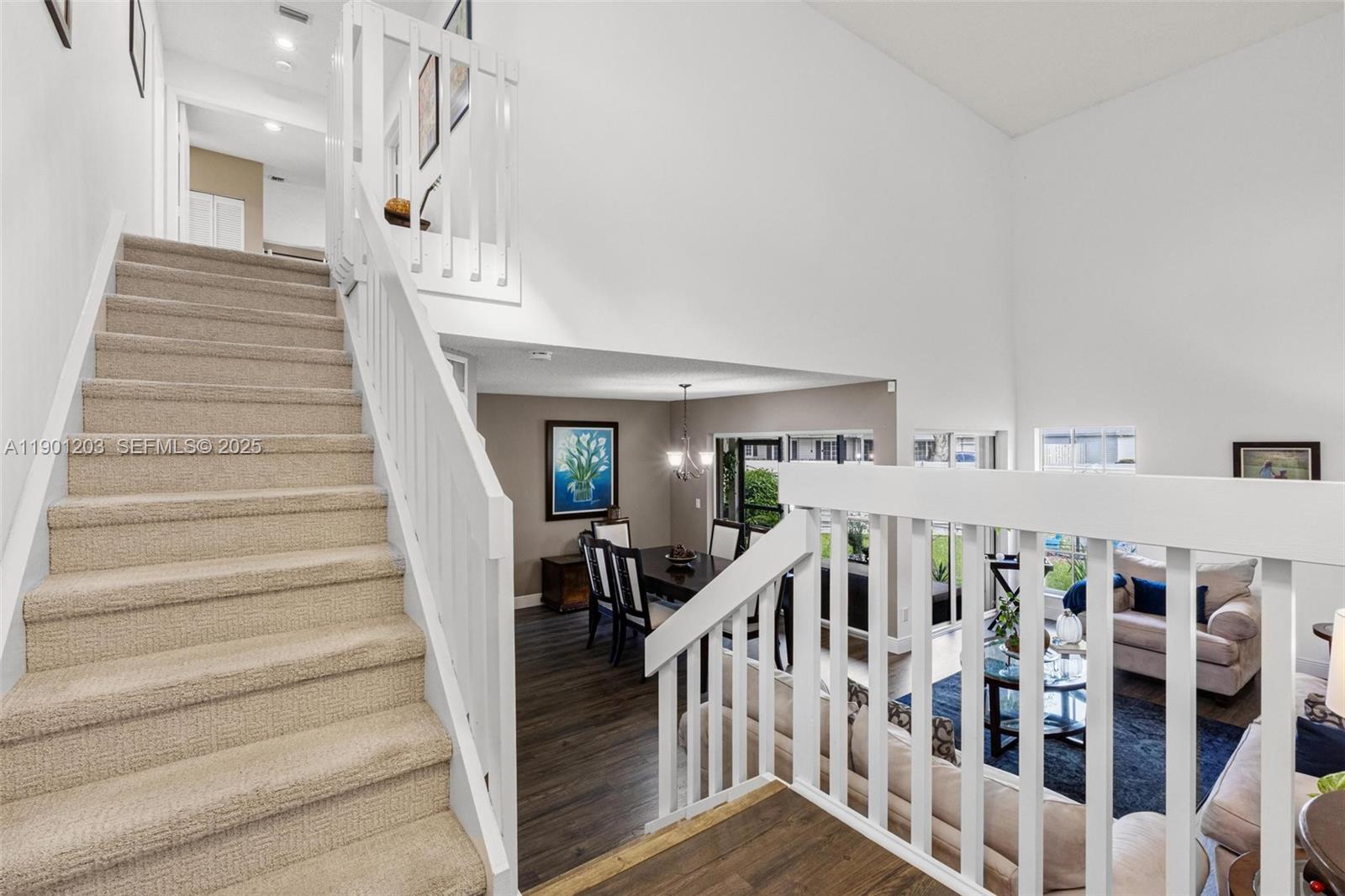 14683 Southwest 145th Terrace Miami, FL 33186 - Photo 4 of 47 a view of staircase with lots of frames on wall and windows