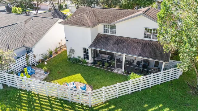 a view of a house with backyard and sitting area