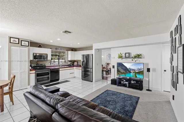 a kitchen with stainless steel appliances granite countertop a refrigerator oven stove top oven a sink and dishwasher