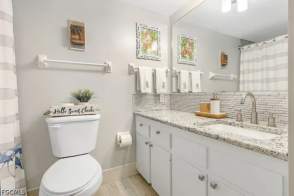 a white toilet sitting next to a bathroom sink