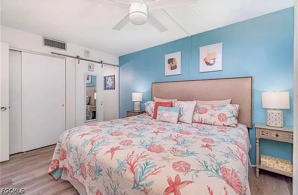 a bedroom with a bed and a lamp