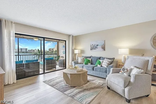 a living room with furniture and a floor to ceiling window