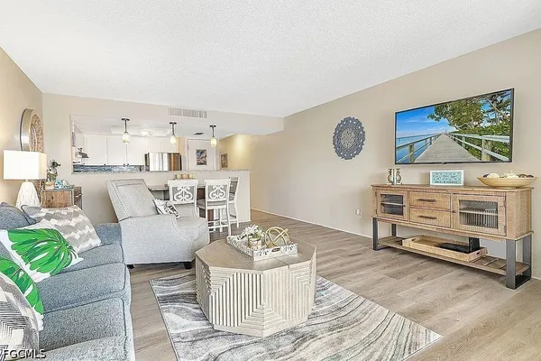 a living room with furniture and a wooden floor