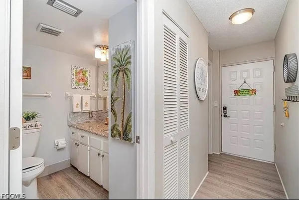 a bathroom with a granite countertop sink a toilet and shower