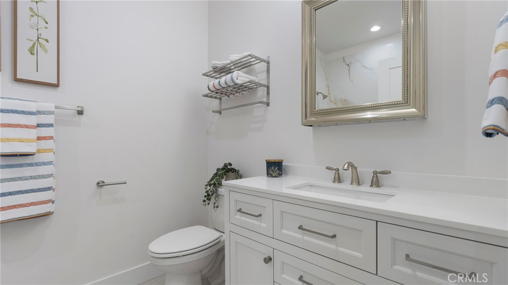 362 South Halcyon Road Arroyo Grande, CA 93420 - Photo 19 of 37 a bathroom with a toilet a sink and mirror
