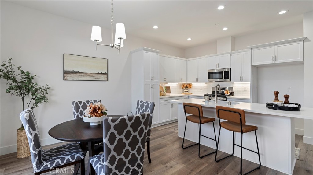 362 South Halcyon Road Arroyo Grande, CA 93420 - Photo 6 of 37 a kitchen with granite countertop a dining table chairs and refrigerator