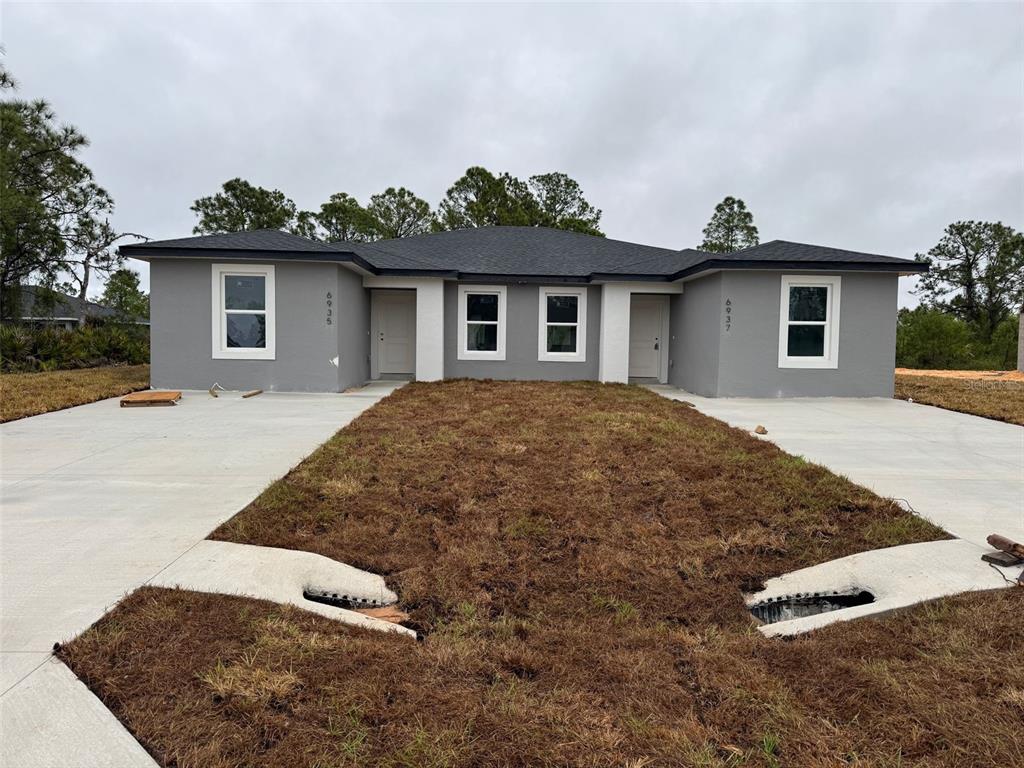 6935 Dickinson Drive Sebring, FL 33872 - Photo 1 of 1 a view of a house with a yard