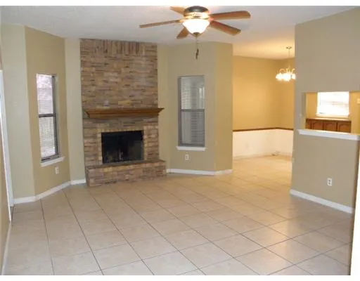a view of an empty room with a fireplace