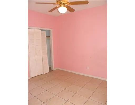 a view of a room with a fan and a window