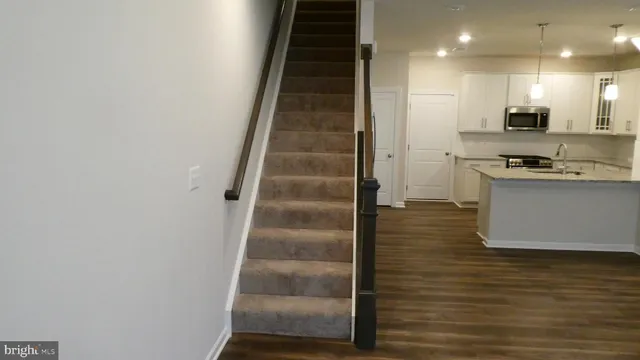 a view of kitchen with microwave and refrigerator