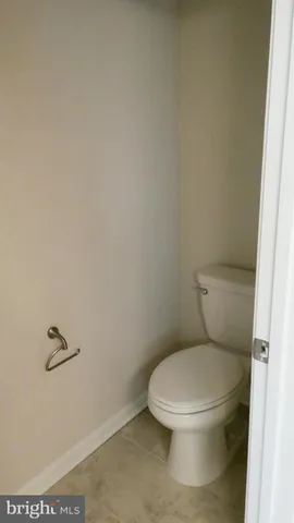 a white toilet sitting next to a sink