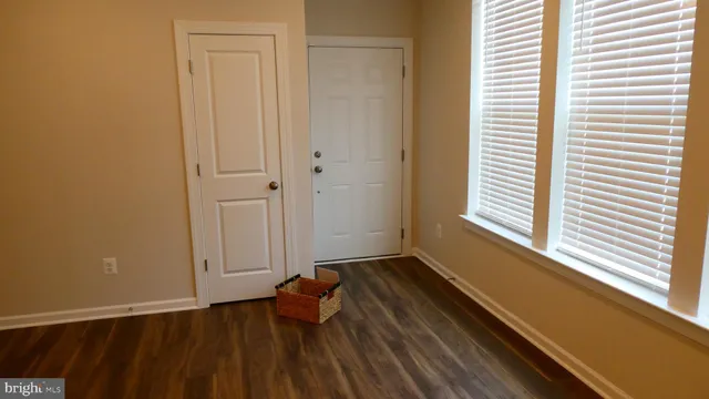 a room with wooden floor and a window