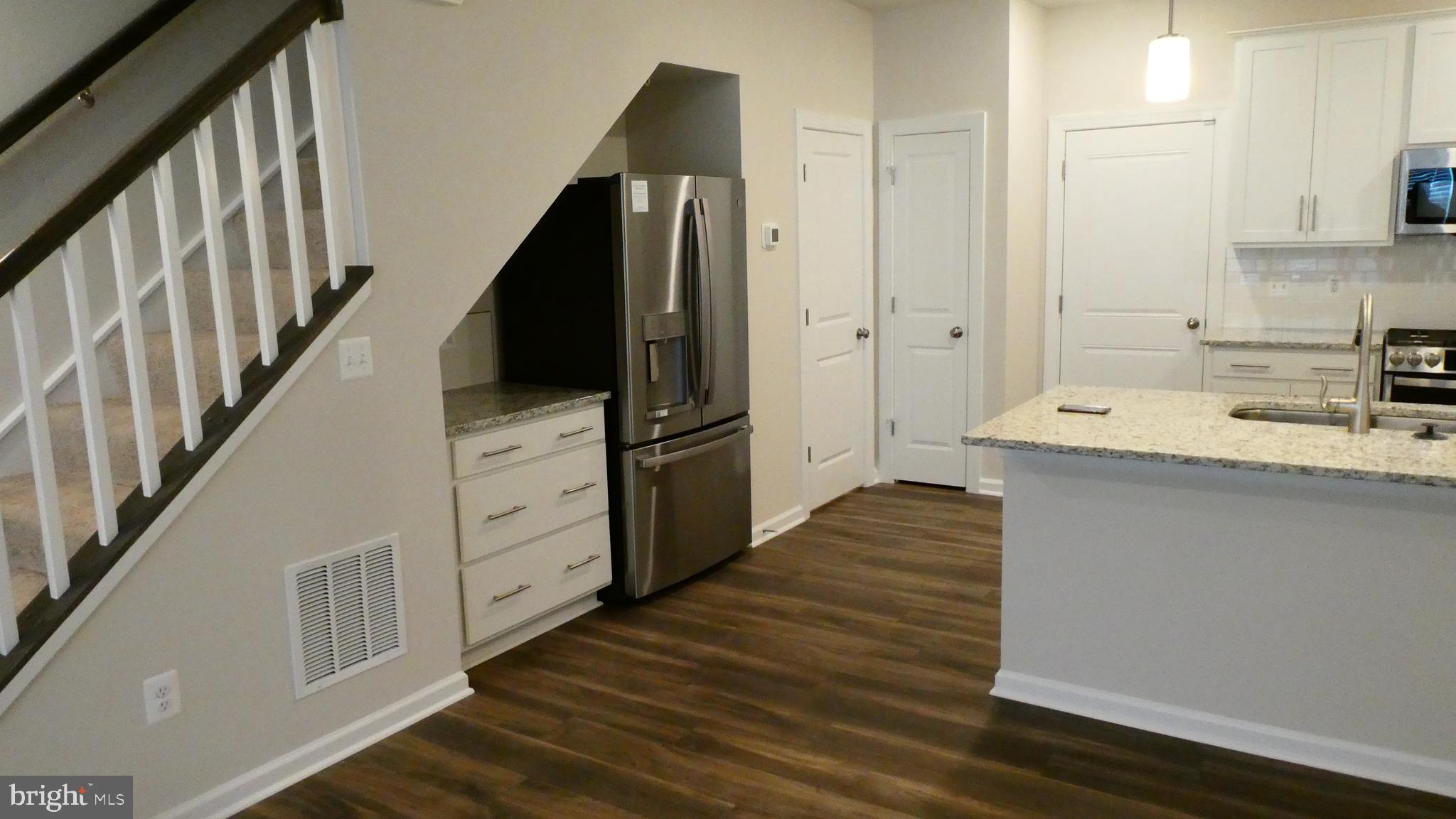 2329 Stephanie Tessa Lane Woodbridge, VA 22191 - Photo 7 of 50 a kitchen with cabinets and wooden floor