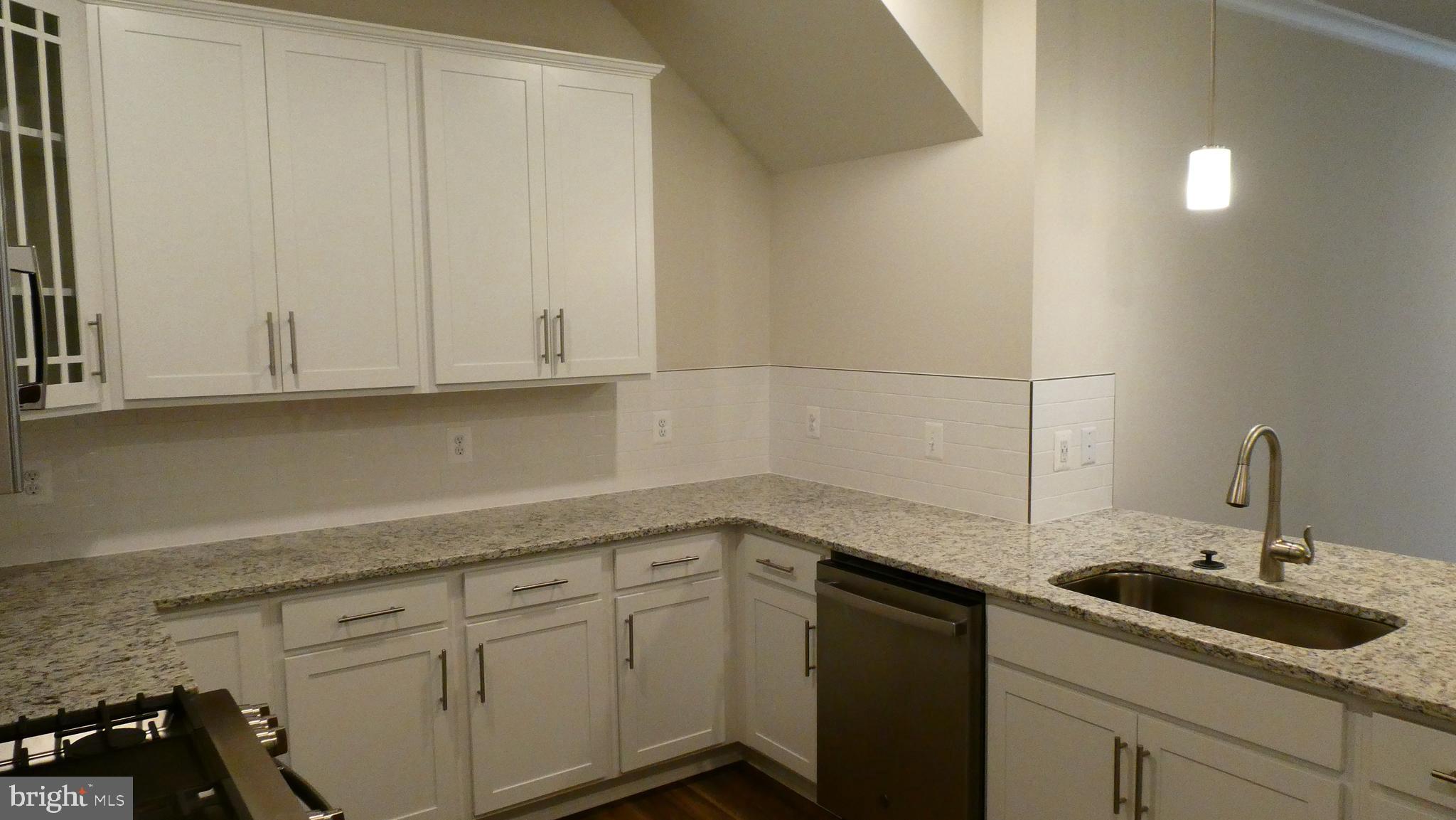 2329 Stephanie Tessa Lane Woodbridge, VA 22191 - Photo 9 of 50 a kitchen with white cabinets and sink