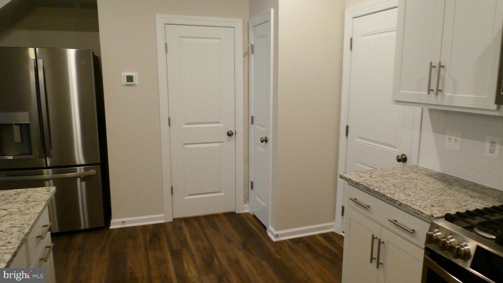 2329 Stephanie Tessa Lane Woodbridge, VA 22191 - Photo 10 of 50 an empty room with wooden floor and cabinets