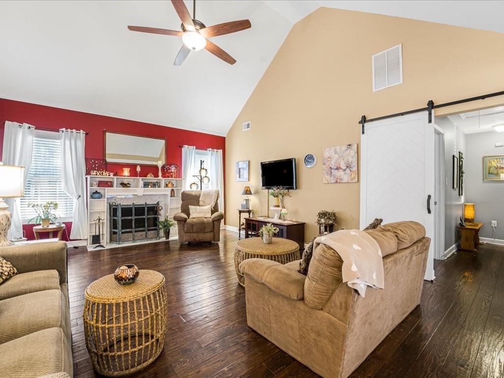 76 Kessle Lane Dallas, GA 30132 - Photo 13 of 33 a living room with furniture gym equipment and a flat screen tv