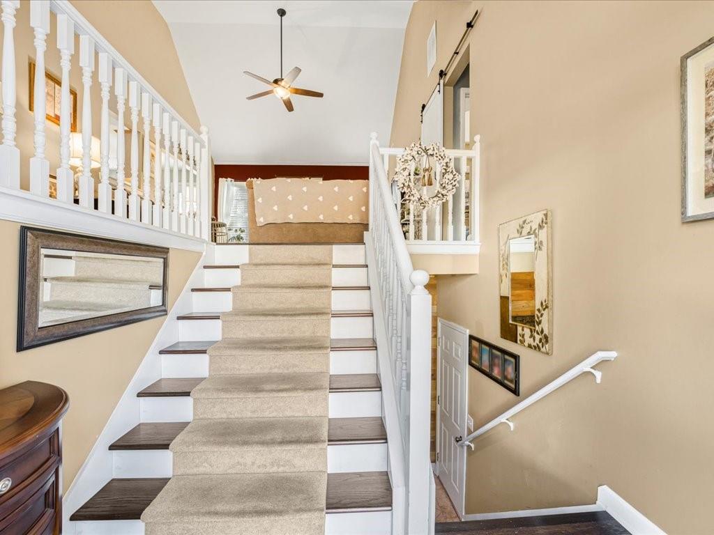 76 Kessle Lane Dallas, GA 30132 - Photo 5 of 33 a view of staircase with lots of frames on wall and a window