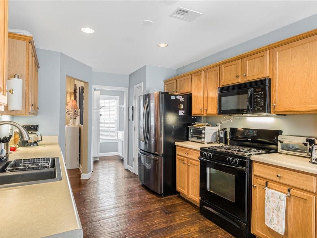 76 Kessle Lane Dallas, GA 30132 - Photo 9 of 33 a kitchen with stainless steel appliances a stove a sink and a refrigerator