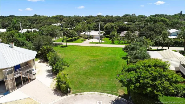 an aerial view of a house with yard