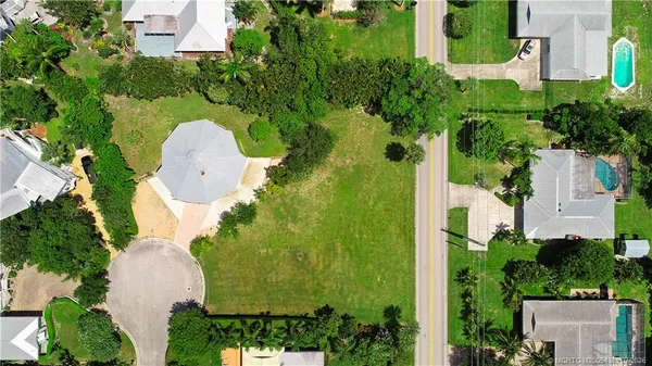 an aerial view of a house with a yard and swimming pool