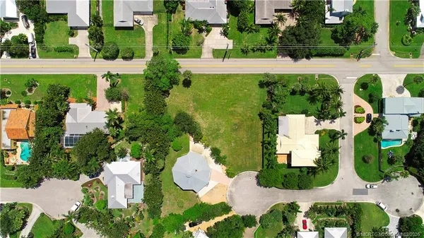 an aerial view of a house with yard swimming pool and outdoor seating