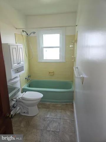 a bathroom with a sink a toilet and a bathtub