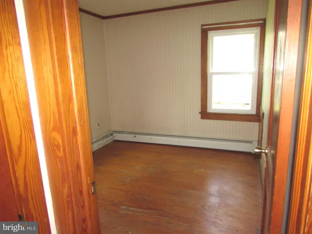 a view of a room with a window and a door