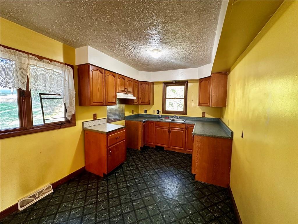 4 Wabash Avenue Hickory, PA 15340 - Photo 11 of 19 a large kitchen with stainless steel appliances granite countertop a sink a stove cabinets counter space and a window