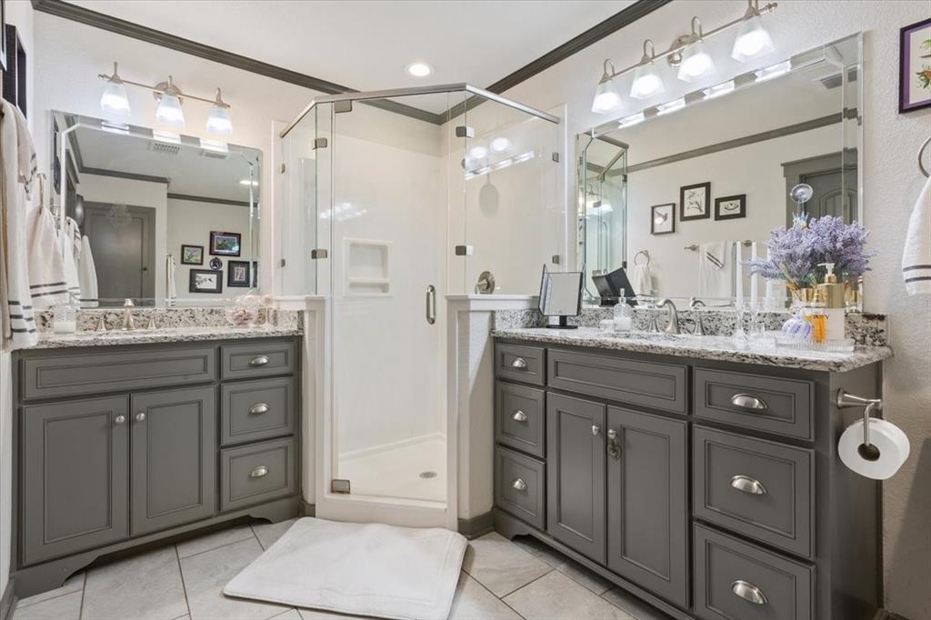 649 Wedgewood Drive China Spring, TX 76633 - Photo 14 of 39 Bathroom with ornamental molding, a stall shower, light tile patterned floors, and two vanities