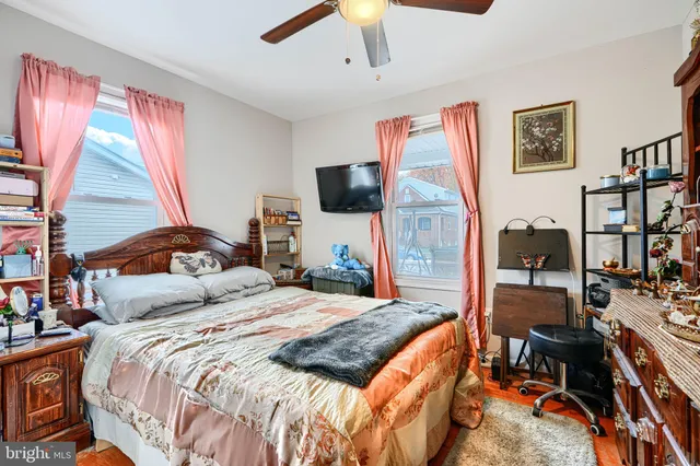 a bedroom with bed and a flat tv screen