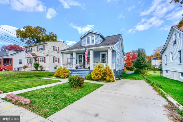 a front view of a house with garden and porch