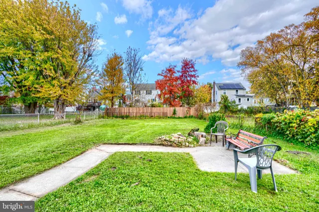 a view of a house with a big yard and potted plants