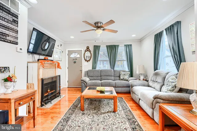 a living room with furniture fireplace and flat screen tv