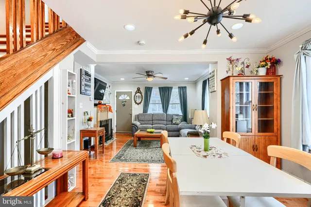 a living room with fireplace furniture and a large window
