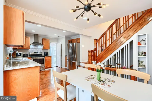 a kitchen view with cabinets a sink and appliances