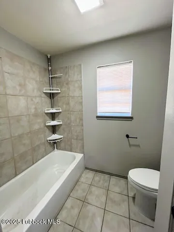 a bathroom with a bathtub and toilet