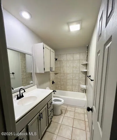 a bathroom with a sink a toilet a mirror and shower