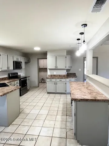 a kitchen with stainless steel appliances granite countertop a sink counter space cabinets and a view of kitchen