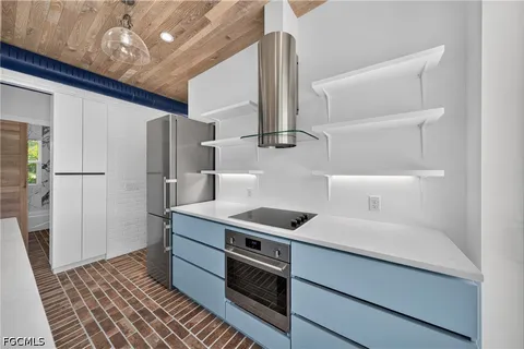 a kitchen with stainless steel appliances a refrigerator and a stove