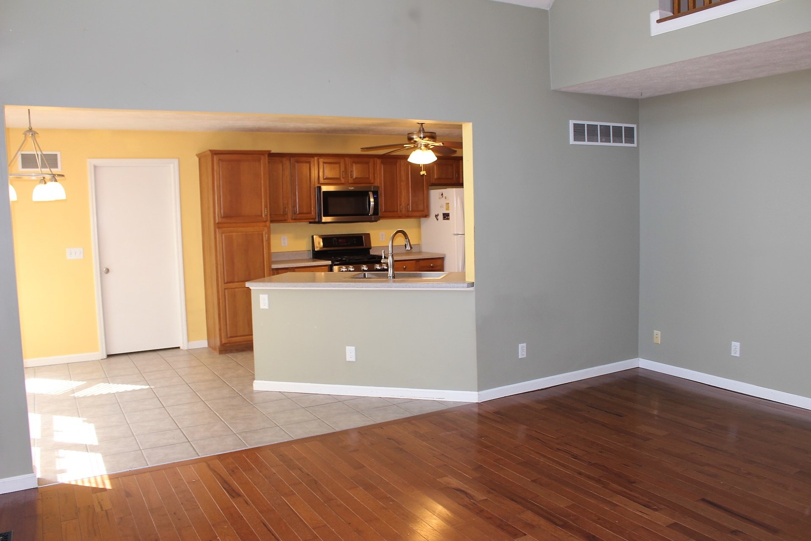 13382 Hickory Grove Road Waynesville, IL 61778 - Photo 16 of 51 a view of a kitchen with a sink and a refrigerator