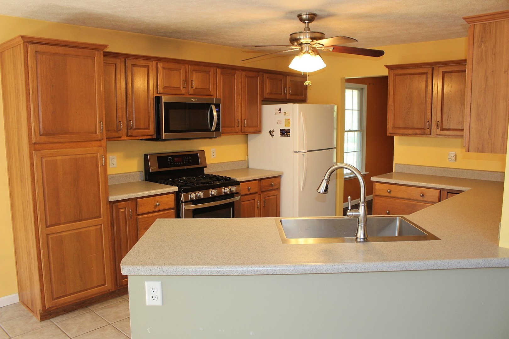 13382 Hickory Grove Road Waynesville, IL 61778 - Photo 17 of 51 a kitchen with stainless steel appliances granite countertop a refrigerator a stove top oven a sink and dishwasher