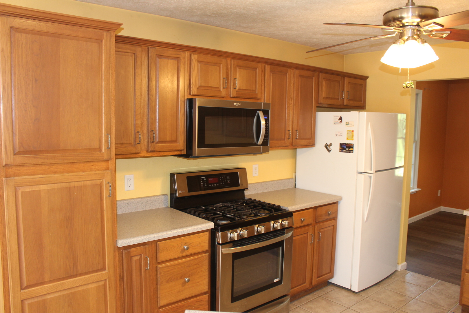 13382 Hickory Grove Road Waynesville, IL 61778 - Photo 18 of 51 a kitchen with stainless steel appliances granite countertop a refrigerator stove a sink dishwasher and microwave