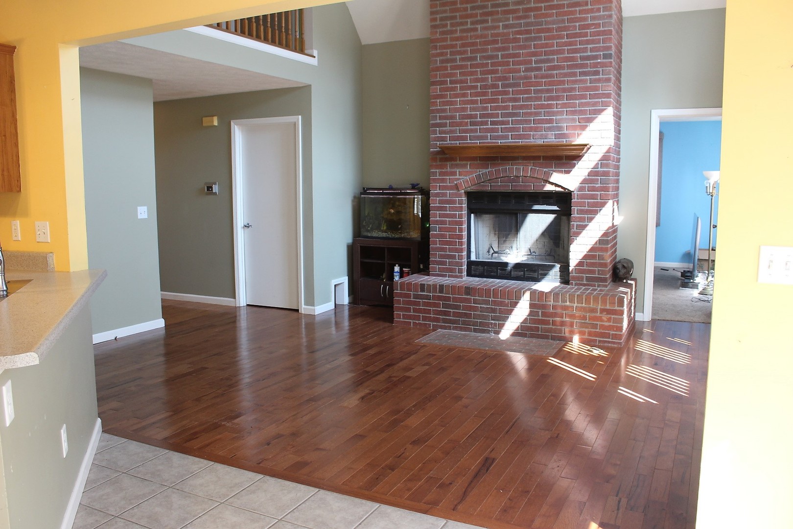 13382 Hickory Grove Road Waynesville, IL 61778 - Photo 24 of 51 a view of a livingroom with wooden floor and a fireplace