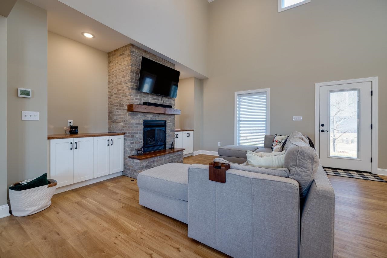 1776 Old Providence Road Raphine, VA 24472 - Photo 24 of 73 a living room with fireplace furniture and a flat screen tv