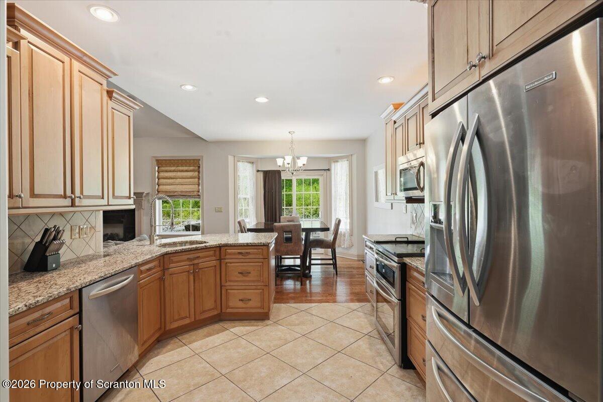 99 Hilltop Road Waverly, PA 18471 - Photo 18 of 41 a kitchen with stainless steel appliances a refrigerator sink and cabinets